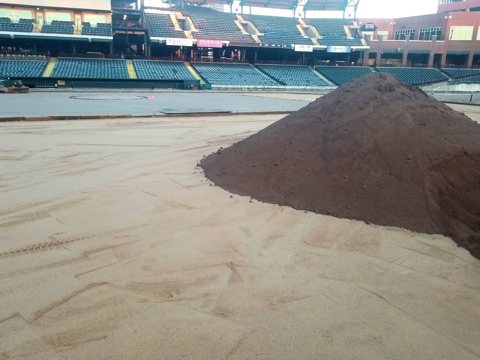 A pile of infield clay ready for use in a sports field.