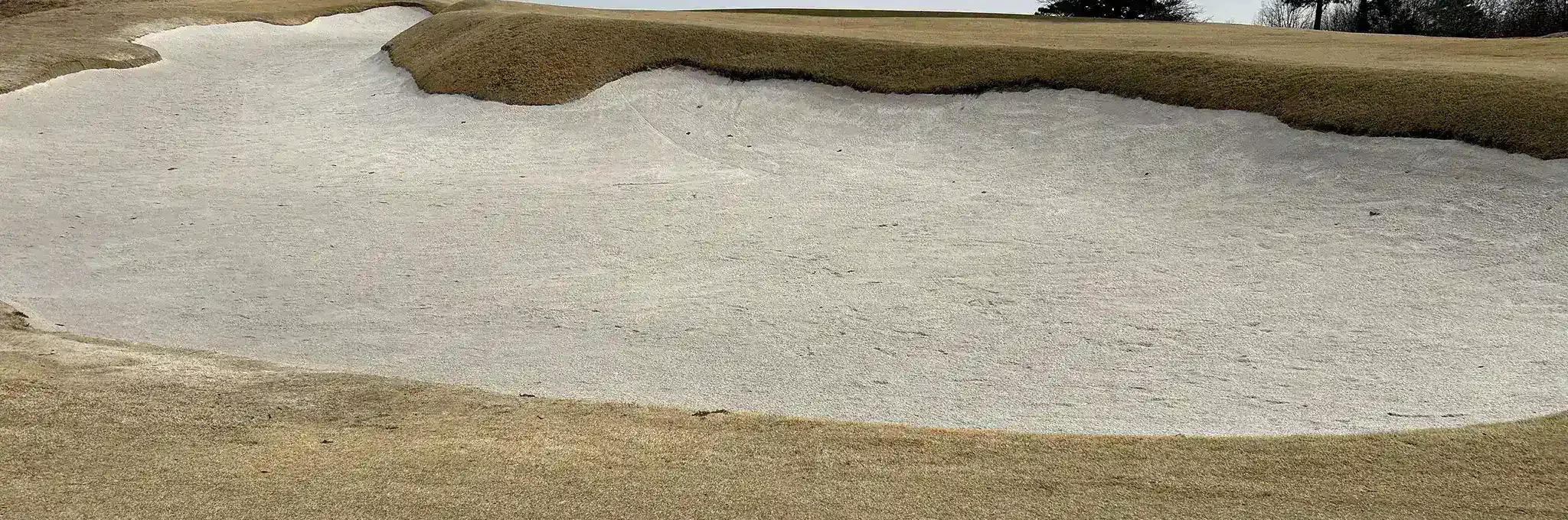 Deeply sloped golf course bunker with Premier Play sand