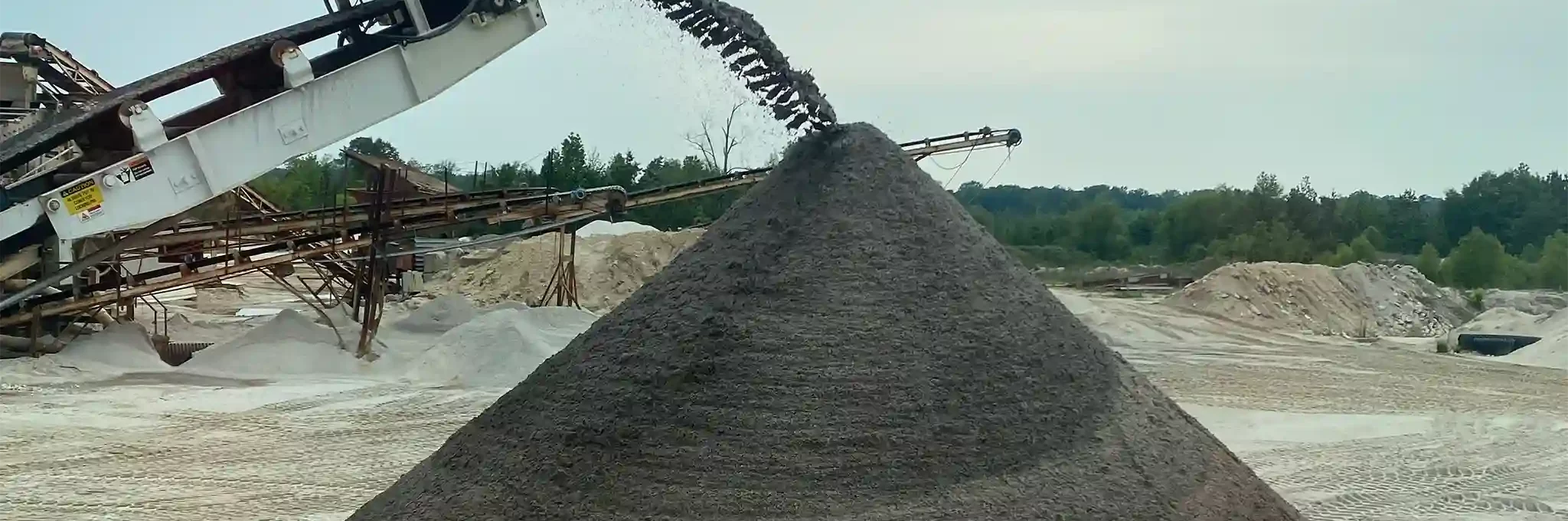 A large pile of 80-20 Greensmix blend being piled outside.