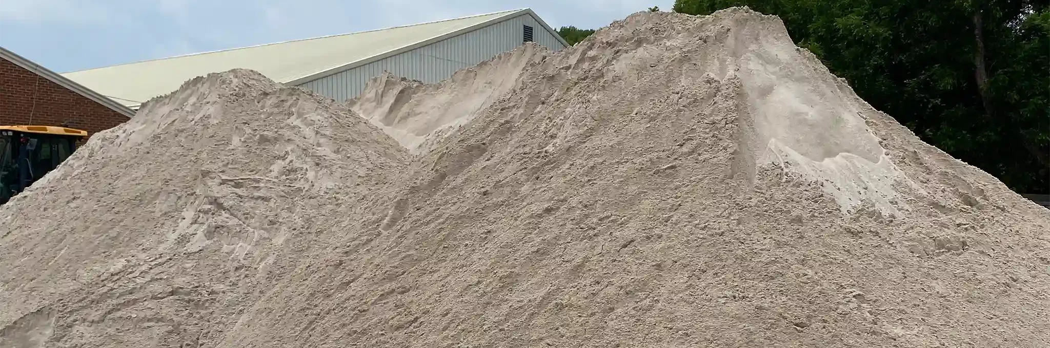 Large piles of greensmix blend stored outside.