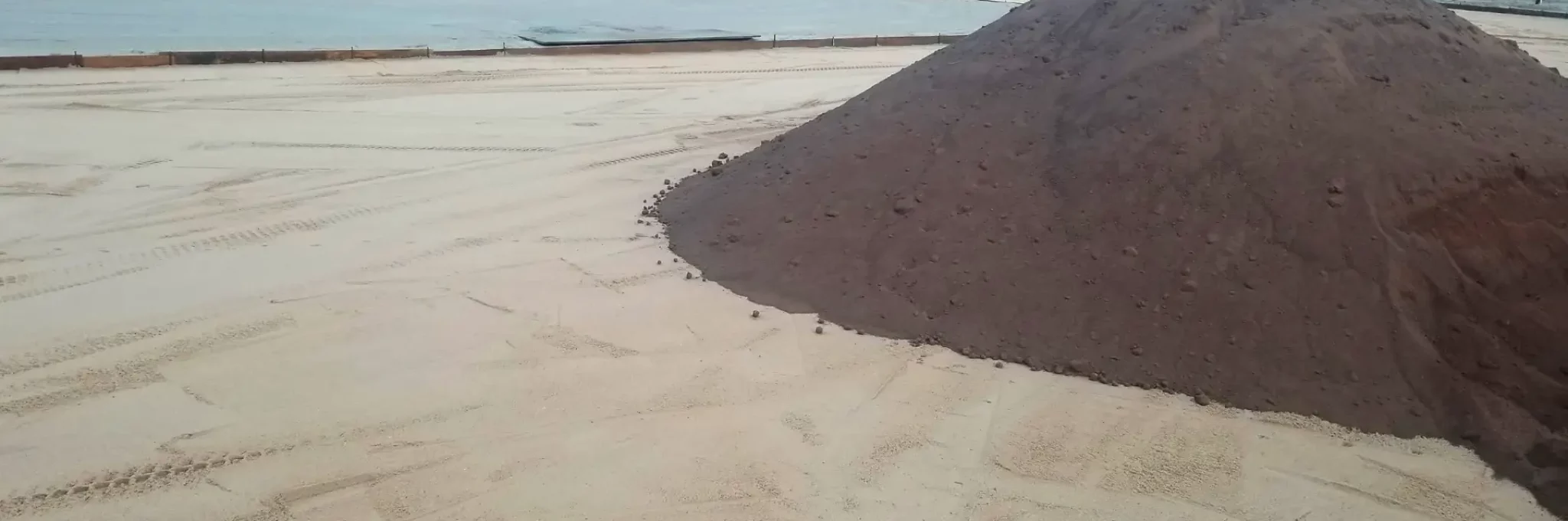 A pile of infield clay ready for use in a sports field.